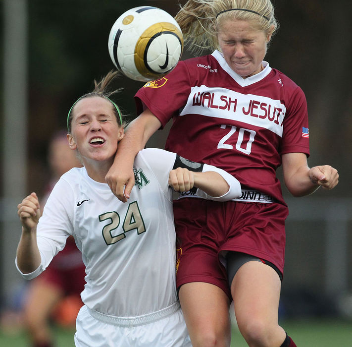 Sports - 2nd placeSt.Vincent - St. Mary's Lexi Mathern (left) and Walsh Jesuit's Christina Trickett vie for a header. (Phil Masturzo / Akron Beacon Journal)