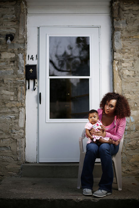 Portrait - 1st place - Deonna Jones, 19, poses for a photograph with her 4-month-old daughter Deonesty at the home of Jones' cousin Kirsten Turner where she is staying. Jones has been staying with different family and friends as she works to make a way for herself and her daughter. Monday was her first day at there new call center position in Hilliard. She is not considered homeless but could be under the new definition of homelessness proposed in a federal bill. Sen. Rob Portman and Rep. Steve Stivers are sponsoring. (Eamon Queeney / The Columbus Dispatch)