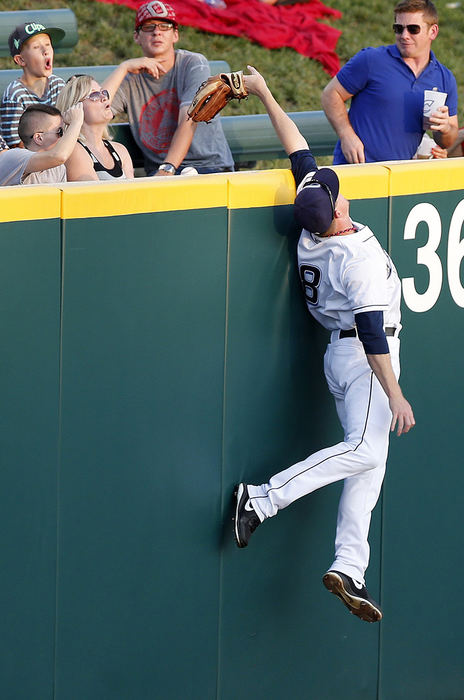 Sports - 2nd place - Columbus Clippers left fielder Elliot Johnson (8) leaps but can't hang on to a home run by Toledo's Jordan Lennerton (12) as his glove comes off at Huntington Park in Columbus.  (Jonathan Quilter / The Columbus Dispatch)