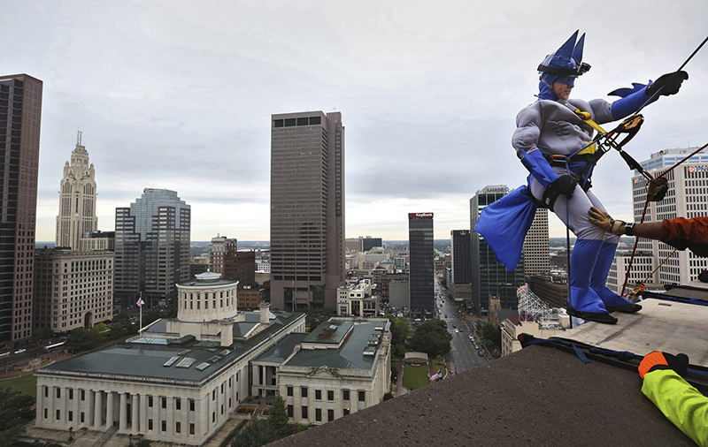 Feature - 1st place - Jeffrey Keirn of Canton dressed as Batman prepares to repel over the edge of the Shearton on Capital Square in Columbus. Keira raised over $2,000 dollars for Shatterproof, a national organization committed to protecting people from addiction.  (Eric Albrecht / The Columbus Dispatch)