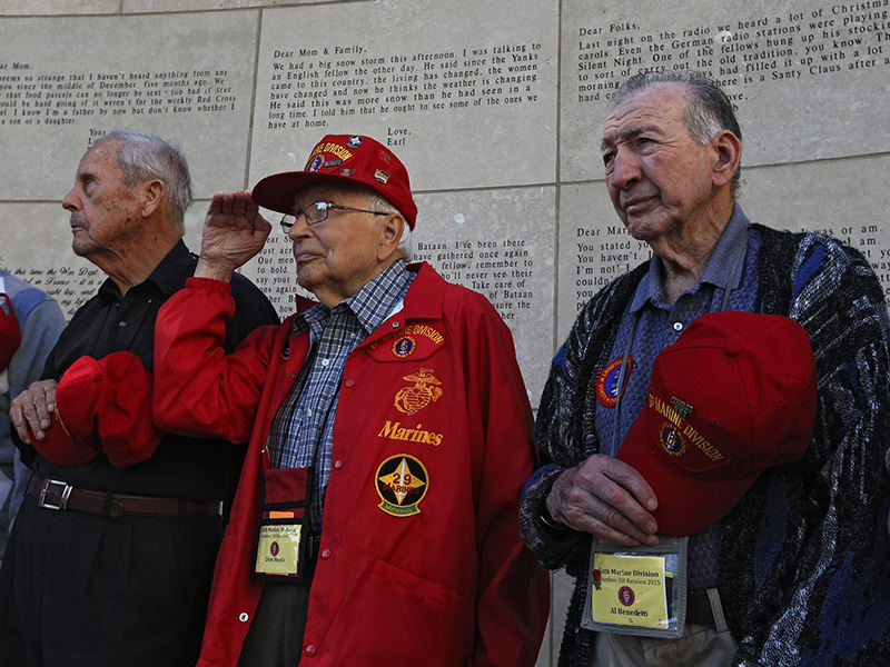 General News - 2nd place - From left: Neal McCallum, Don Honis , and Al Benedetti pay their respects during taps during a wreath laying ceremony at the Ohio Statehouse. Remaining members of the Sixth Marine Division had a wreath laying ceremony at the Ohio Statehouse. The Sixth Marines Division participated last and bloodiest battle in Okinawa the battle of Sugar Loaf Hill in WWII.  (Eric Albrecht / The Columbus Dispatch)