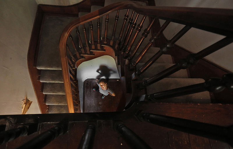 Portrait - 1st place - Jessica Kittrell hopes to salvage the Cherry staircase at 5051 Brand Rd. in Dublin.  (Tom Dodge / The Columbus Dispatch)