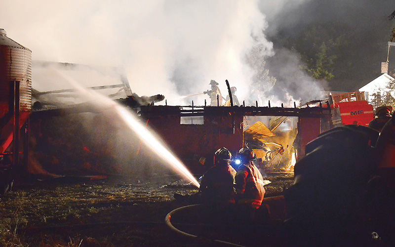 Spot News - 3rd place - Firefighters from six area departments, under the light of a full moon, kept the blaze contained to the barn and saved the house, although they lost a large garage that sat adjacent to the barn.  (Patricia Schaeffer / The (Lisbon) Morning Journal)