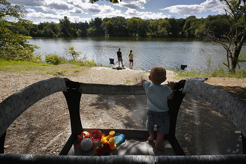 Feature - 2nd place - Zander Peterson, 10 months, had a crib with a view during his first fishing trip with Zach and Tiffanee Peterson. They were fishing in the Scioto River at Griggs Reservoir.  (Tom Dodge / The Columbus Dispatch)