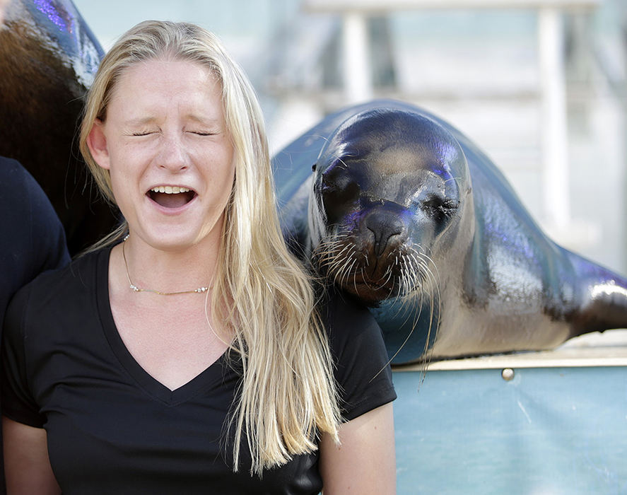 Feature - 3rd place - Anya DuVivier, from New York City and studying law at Capital University, reacts as she poses for a photo with a sea lion named Kim at the Ohio State Fair. (Barbara J. Perenic / The Columbus Dispatch)