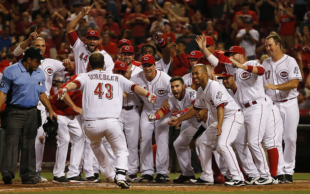 SSports Feature - 1st place - Cincinnati Reds center fielder Scott Schebler (43) leaps on home plate after hitting a three-run walk-off home run in the bottom of the ninth inning against the St. Louis Cardinals  at Great American Ball Park in Cincinnati. The Reds won 7-5. (Kareem Elgazzar / Cincinnati Enquirer)