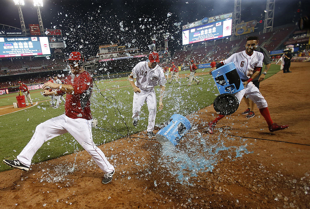 SSports Feature - 2nd place - Cincinnati Reds center fielder Scott Schebler (far left) is dunked by Reds starting pitcher Homer Bailey (34) and center fielder Billy Hamilton (6) after hitting a three-run, walk-off home run in the bottom of the ninth inning against the St. Louis Cardinals at Great American Ball Park in Cincinnati. The Reds won 7-5. (Kareem Elgazzar / Cincinnati Enquirer)