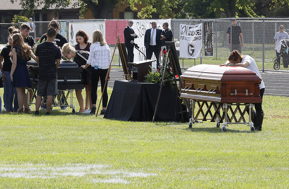 General News - HM - Friends and family of Connor Williams and David Waag say their goodbyes during a joint funeral service for the Greenon High School students at the Greenon football stadium.  (Bill Lackey / Springfield News-Sun)