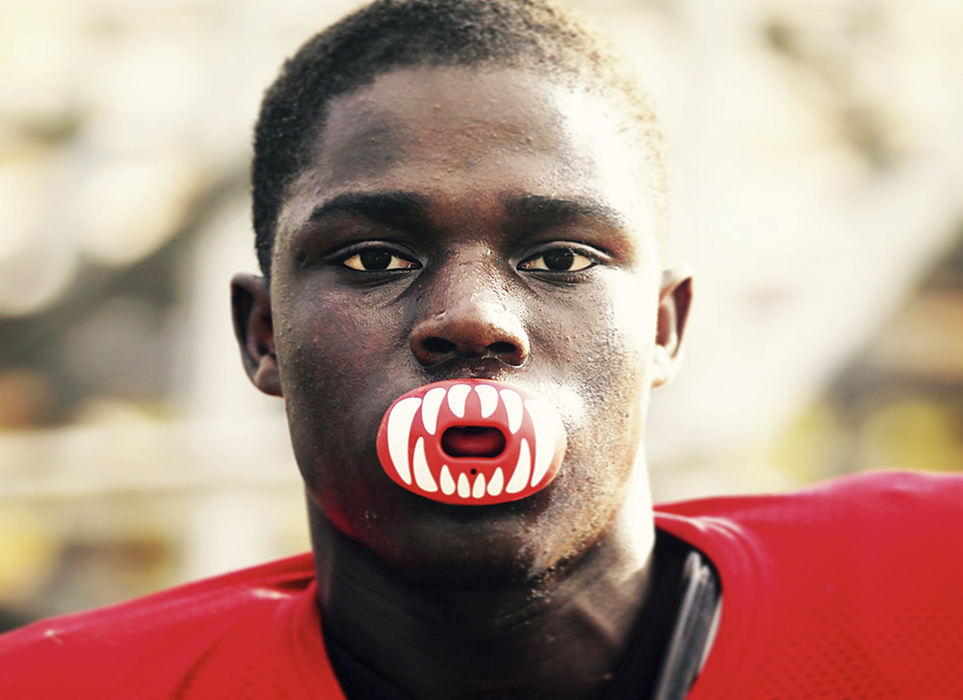 Sports Feature - HM - Utility player Bangally Kamara poses for a picture with his decorative mouthguard during Kenmore-Garfield practice at Kenmore Stadium in Akron. (Leah Klafczynski / Akron Beacon Journal)