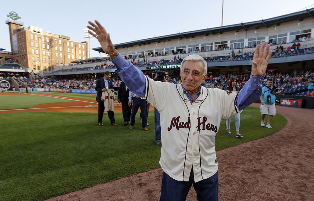 Sports Feature - HM - Toledo's favorite son Jamie Farr waves to the crowd as he is introduced before the Toledo Mud Hens play the Louisville Bats at Fifth Third Field in Toledo.  Farr, who played the beloved character Max Klinger on the TV series M*A*S*H, donated the jersey he wore on the show to the Mud Hens before the game.    (Andy Morrison / The Blade)