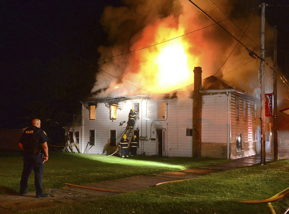 Spot News - 1st place - Firefighters from two departments responded to a blaze at 62 Main St., Salineville with the old building found engulfed in flames.  (Patricia Schaeffer / The (Lisbon) Morning Journal)