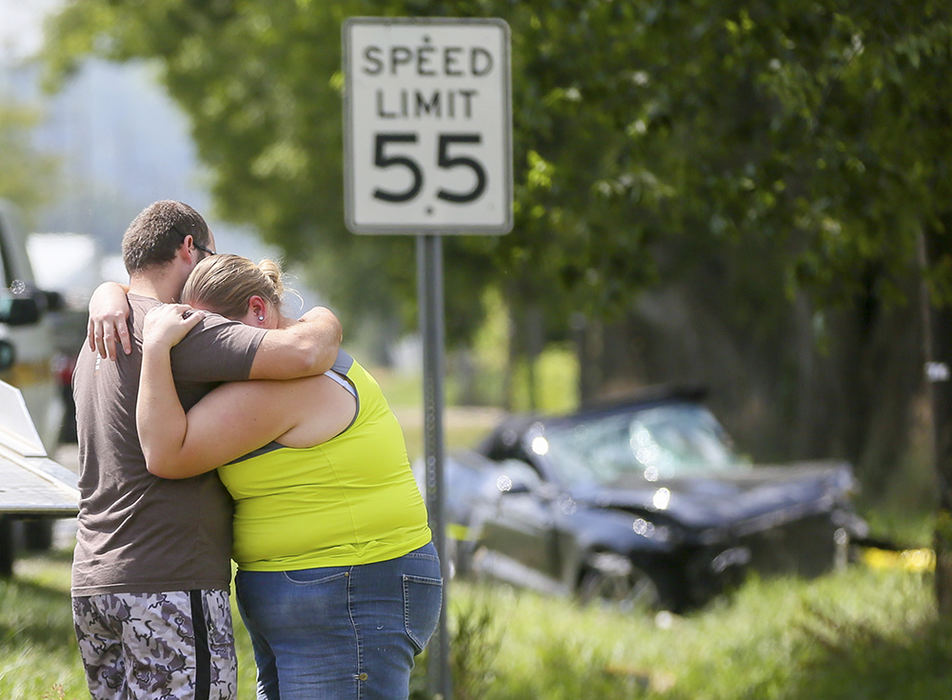 Spot News - 3rd place - Lisa and Dustin Jordan embrace at the scene of a fatal crash on Ross-Millville Road involving two cars, with a third car also being side-swiped. A woman was killed at the scene and another person was transported by ambulance to an area hospital.  (Greg Lynch / Hamilton Journal-News)