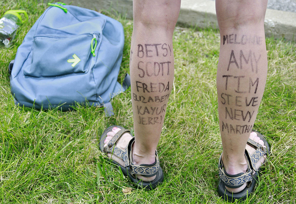 Story - HM - Names of a rider's honorees are written on her legs at the Pelotonia finish line in New Albany. (Barbara J. Perenic / The Columbus Dispatch)