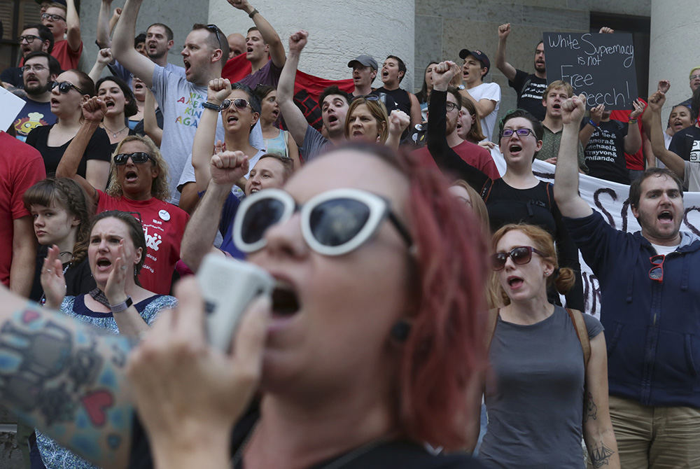 MT Story - HM - Kelly Weber leads protestors in chants to remember  Heather Heyer who was killed at a counter protest in  Charlottesville Va. Hundreds marched downtown to the Ohio Statehouse from Goodale Park. (Eric Albrecht / The Columbus Dispatch)