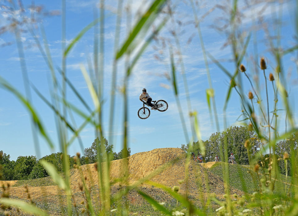 Sports Feature - 1st place - Professional cyclist, Tommy Zula of Dayton performs a stunt at the Lebanon Bike Park. Zula who is sponsored by Airborne Cycles out of Springboro is the reigning Red Bull UCI Pump Track World Champion and was training to keep his skill sharp until UCI races resume next season. Erik Schelkun / Elsestar Images