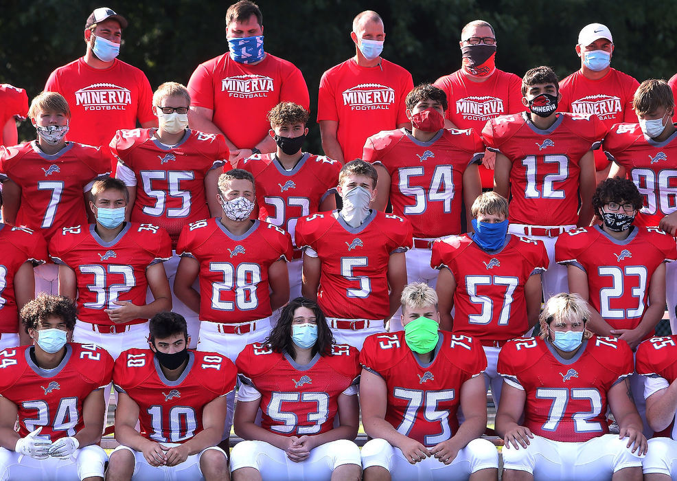 Sports Feature - 3rd place - High school football players and coaches wear masks during their photo day in Minerva. They wore the face coverings as their team photo was setup and briefly took them off when the photo was actually taken.  Scott Heckel / The Canton Repository