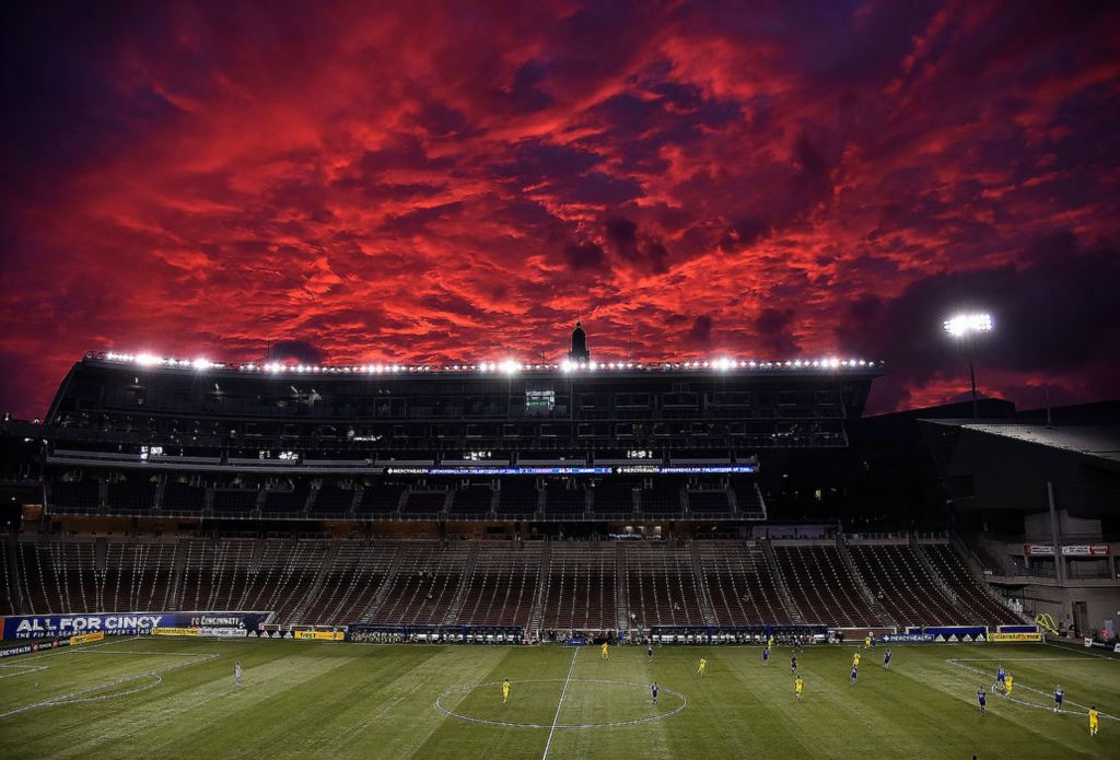 Sports Feature - HM - A colorful sunset steals the show for a few minutes during the first half of an MLS match between FC Cincinnati and the Columbus Crew at Nippert Stadium on the campus of the University of Cincinnati.  Erik Schelkun / Elsestar Images