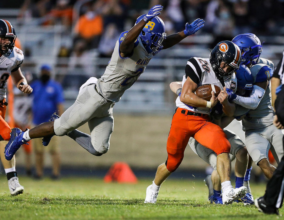 Sports - 1st place - Northwood's Kyeon Neal (29) jumps to bring down Gibsonburg's Connor Smith (20) during the first high school football game of the season at Northwood High School.  Rebecca Benson / The Blade