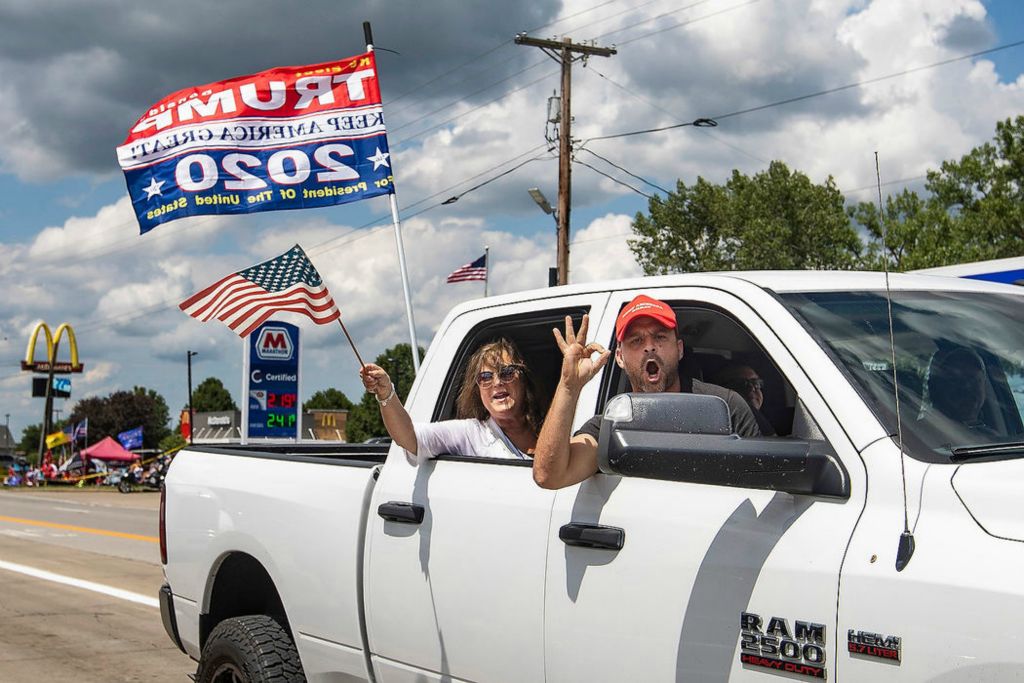 Story - 1st place - Trump supporters yell as they lean out of their car while driving along Route 20 ahead of President Trump's arrival to the Whirlpool facility in Clyde. Rebecca Benson / The Blade