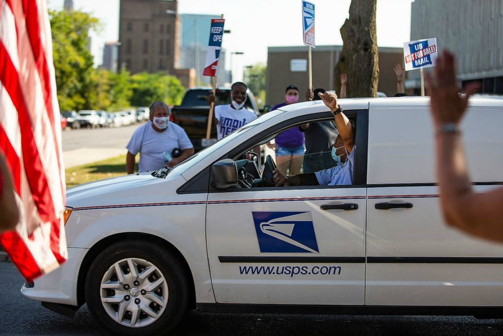 Story - 2nd place - A mailman gives a thumbs up out of his car window as he drives by a "Save the Post Office" rally at the main Toledo Post Office. Rebecca Benson / The Blade