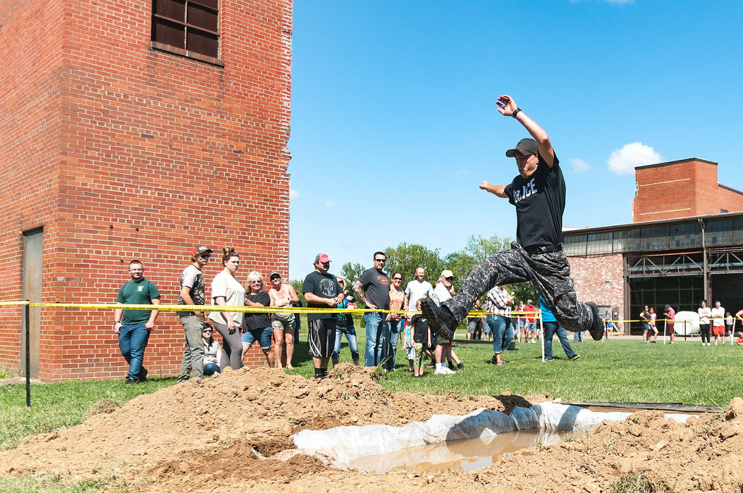 General News - 1st placeMount Vernon Emergency Services Unit member Aaron Collins leaps over a pit of water during the Tactical Combat Obstacle Challenge at Ariel-Foundation Park. (Joshua Morrison / Mount Vernon News)