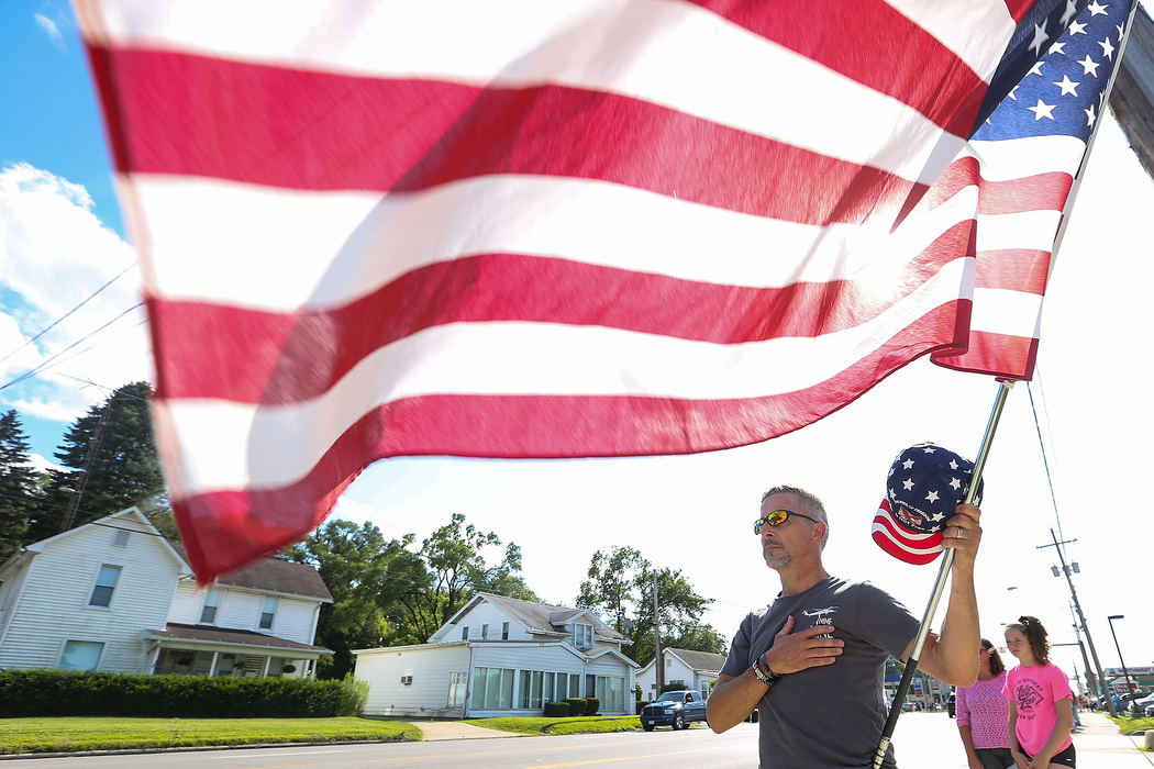 General News - 2nd placeJim Ankoviak puts his hand over his heart during the procession of Army Private First Class Brandon Kreischer along Airport Highway in Swanton, Ohio. Kreischer was killed in action in Afghanistan.  (Rebecca Benson / The Blade)