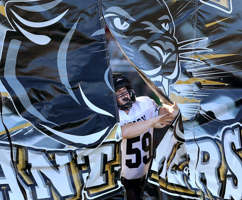 Sports Feature - 3rd placePerry's Carter Huff breaks through their banner prior to their game at Central Catholic. (Scott Heckel / The Canton Repository)