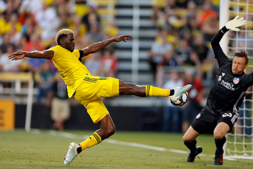 Sports - 2nd placeColumbus Crew SC forward Gyasi Zardes (11) tries to get a ball past FC Cincinnati goalkeeper Przemyslaw Tyton (22) during the first half of the MLS soccer match at Mapfre Stadium in Columbus. (Adam Cairns / The Columbus Dispatch)