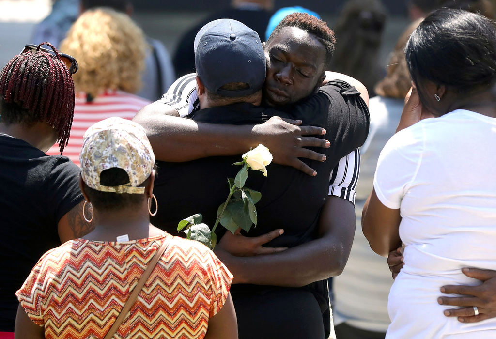 Story - 1st placeDayton resident Donna Johnson (front) whose nephew Thomas McNichols was killed in the shooting, receives a hug from Caleb White, also from Dayton during a vigil at Levitt Pavilion Dayton. The afternoon vigil was held after mass shooting that took place down the street in the Oregon District overnight.  (Kurt Steiss / The Blade)