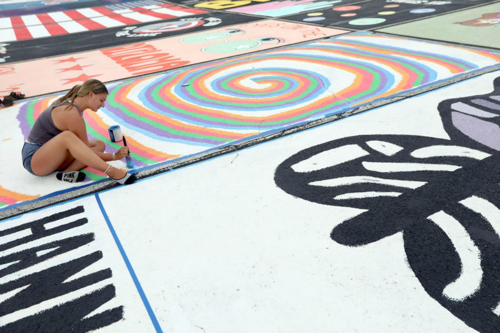 Feature - 3rd place - Senior Zoee Root paints her parking space at Clay High School. This is the third year that seniors painted their parking spot to kick-off their last year of high school.   (Amy E. Voigt / The Blade)