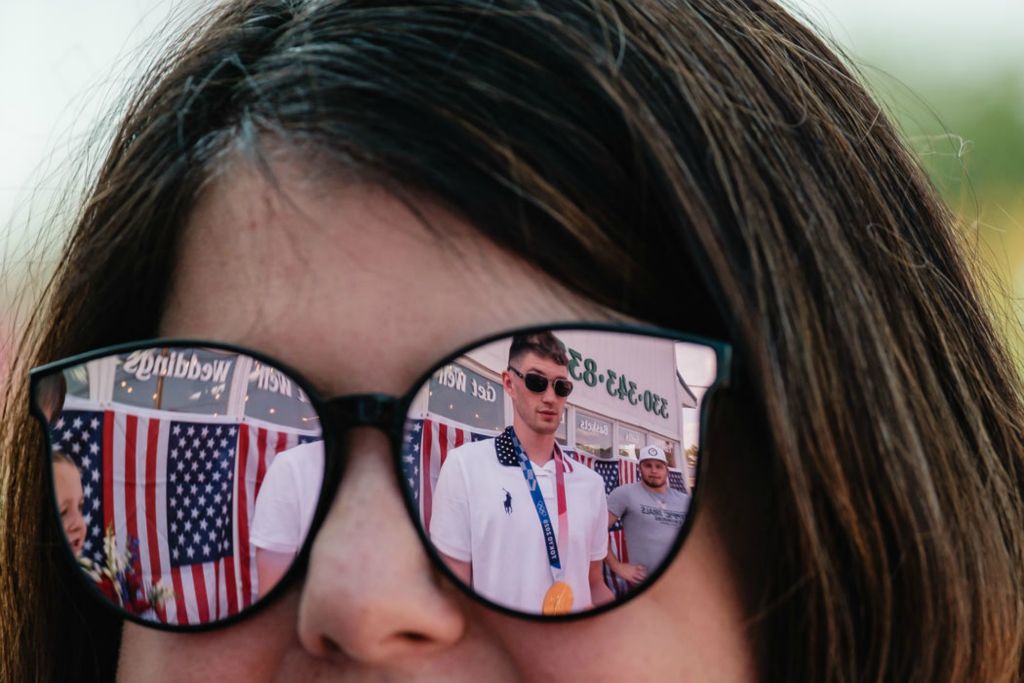 General News - HM - Hunter Armstrong and his brother, Jake (right) are reflected in the glasses of Jenny Mathias, from Dover, during a community meet and greet at Pam's Posies in Dover. (Andrew Dolph / The Times Reporter)