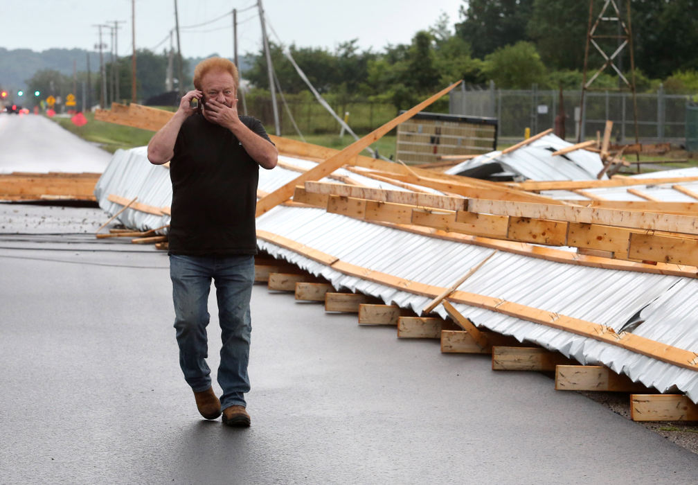 Spot News - HM - Michael Handy, owner of Handy Equipment, reacts after a storm blew the roof off his business on State Route 800 in Sandy Township in Tuscarawas County. The roof had only been on the building for a couple months according to the owner. (Scott Heckel / The Canton Repository)