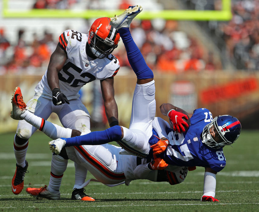 Sports - 1st place - New York Giants wide receiver Damian Willis (87) is brought down by Cleveland Browns cornerback A.J. Green (38) and outside linebacker Elijah Lee (52) after a catch during the second half of a preseason game in Cleveland. (Jeff Lange / Akron Beacon Journal)