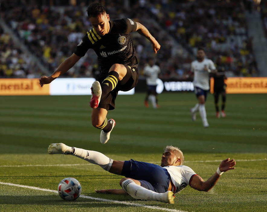 Sports - 2nd place - Columbus Crew midfielder Lucas Zelarayan (10) jumps over D.C. United defender Tony Alfaro (93) during the first half of their MLS game at Lower.com Field in Columbus.  (Kyle Robertson / The Columbus Dispatch)