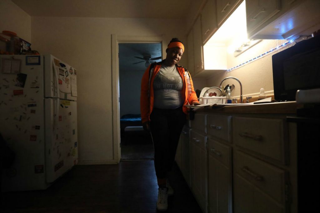 Story - 2nd place - Navielle Lofton stands in her kitchen at her apartment on Brooke Park Dr. Lofton is fighting the eviction from Neighborhood Properties, Inc.   (Amy E. Voigt / The Blade)