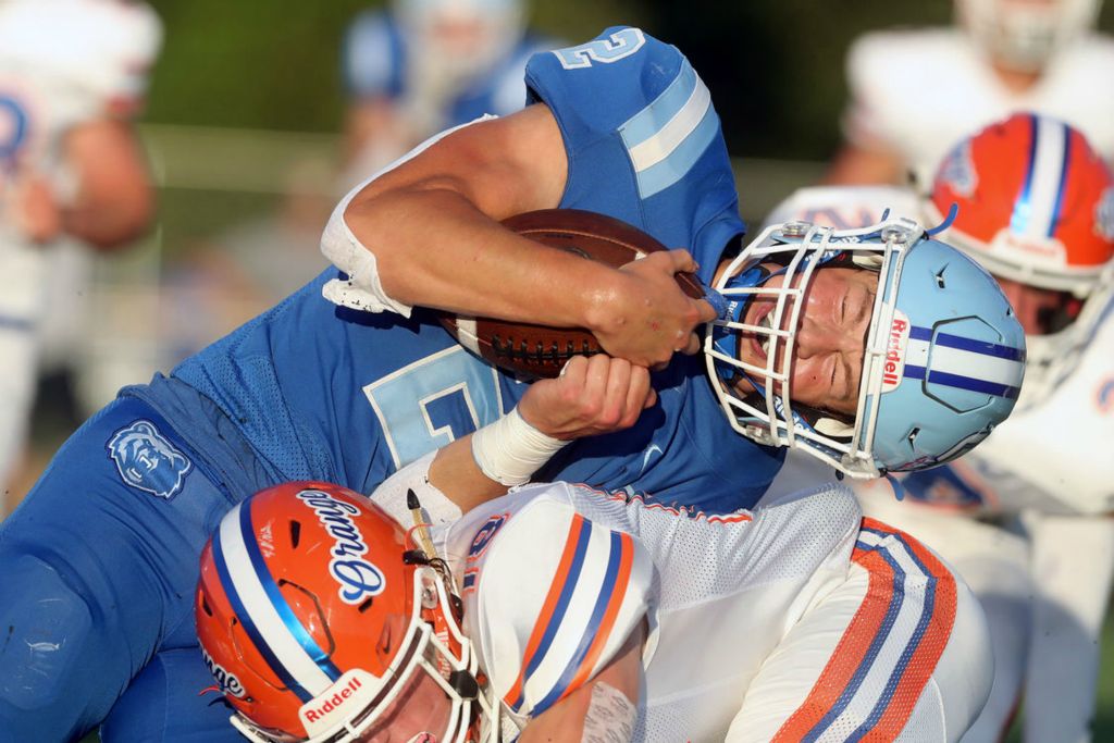 Sports - 2nd place - Olentangy Berlin's Harrison Brewster takes a shot from Olentangy Orange's Ayden Hanna as he crosses the goal line for a touchdown at Olentangy Berlin High School in Delaware. (Shane Flanigan / ThisWeek Community News)