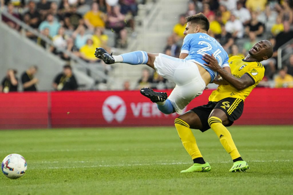 Sports - 3rd place - New York City midfielder Nicolás Acevedo (26) collides with Columbus Crew midfielder Darlington Nagbe (6) during the first half of a match at Lower.com Field.  (Adam Cairns / The Columbus Dispatch)