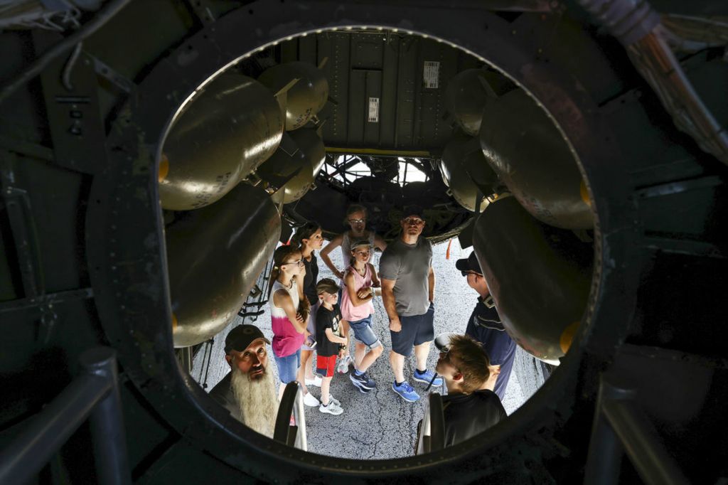 Story - 3rd place - Bill Czinski, bottom left, of Tecumseh, Mich., looks inside of a Boeing B-29 Superfortess during the Commemorative Air Force AirPower History Tour Friday, August 19, 2022, at Eugene F. Kranz Toledo Express Airport in Swanton. (Jeremy Wadsworth / The Blade)