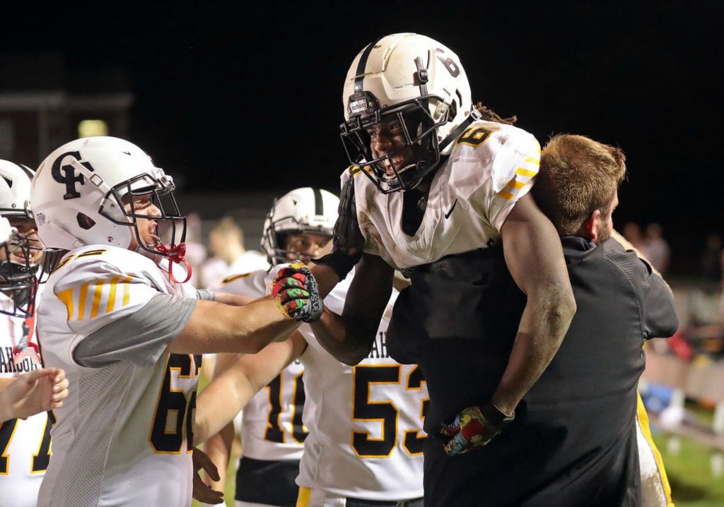 Sports Feature - 3rd place - Cuyahoga Falls running back Zavier Lindsey celebrates with his team after his 64-yard touchdown run against Springfield during the second half of a high school football game in Akron. (Jeff Lange / Akron Beacon Journal)