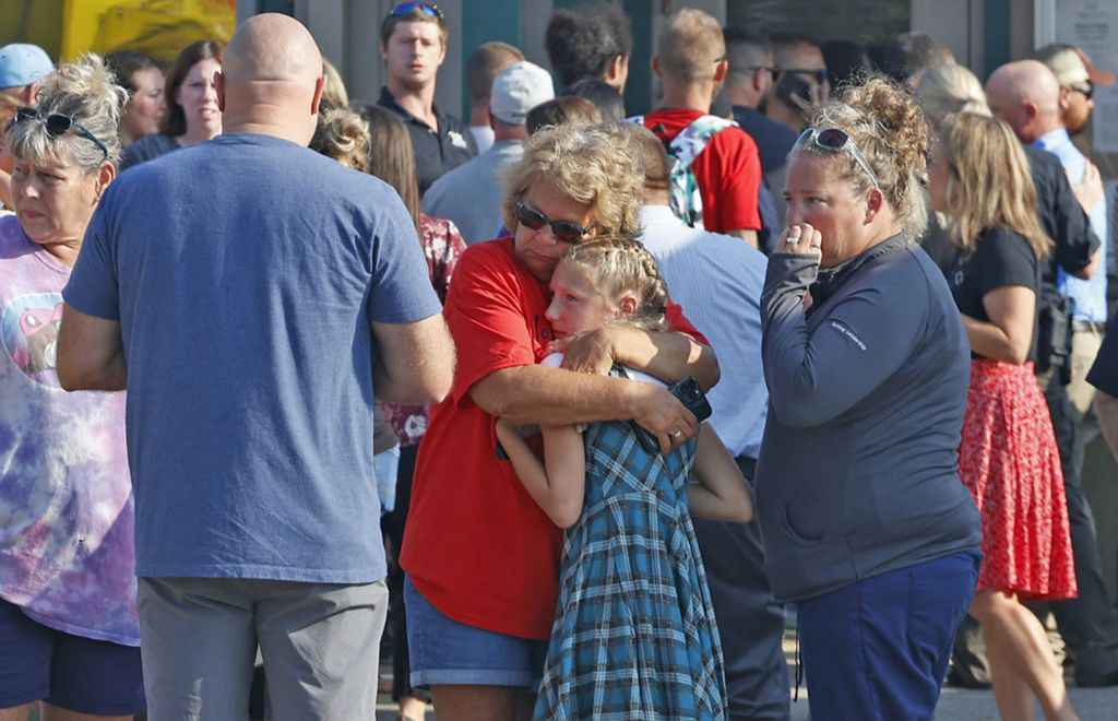 Spot News - 2nd place - Family members are reunited with their children at the German Township Government Center following a Northwestern School District bus crash on State Route 41. One student was killed and more than 20 others were injured. The bus, carrying 52 elementary students on their way to the first day of school was struck by a mini van and rolled over. (Bill Lackey / Springfield News-Sun)