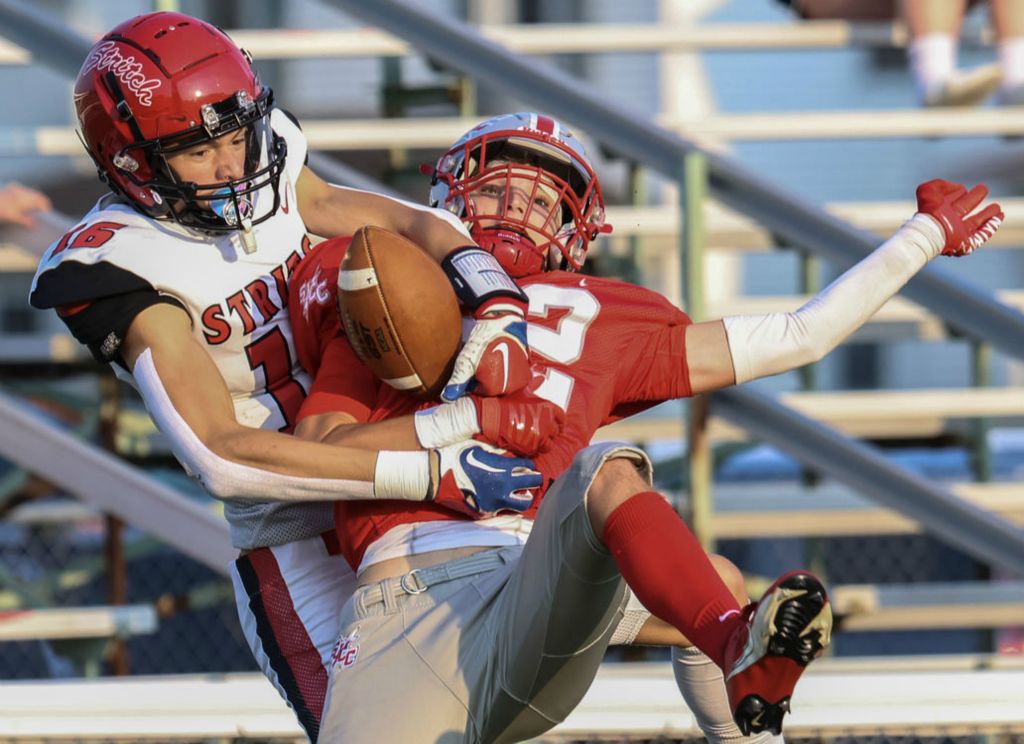 Sports - 2nd place - Cardinal Stritch wide receiver Nathan Frontline (left) makes a catch against  St. Joseph Central Catholic linebacker Oliver Wright during a high school football game at Don Paul Stadium in Fremont.  (Jeremy Wadsworth / The Blade)