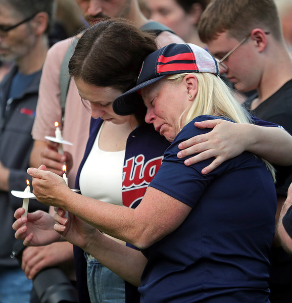 General News - 2nd place - Loved ones embrace during a vigil held outside city hall for Megan Keleman, the 25-year-old who was shot and killed in a Taco Bell drive-thru in Stow. (Jeff Lange / Akron Beacon Journal)   (Jeff Lange / Akron Beacon Journal)