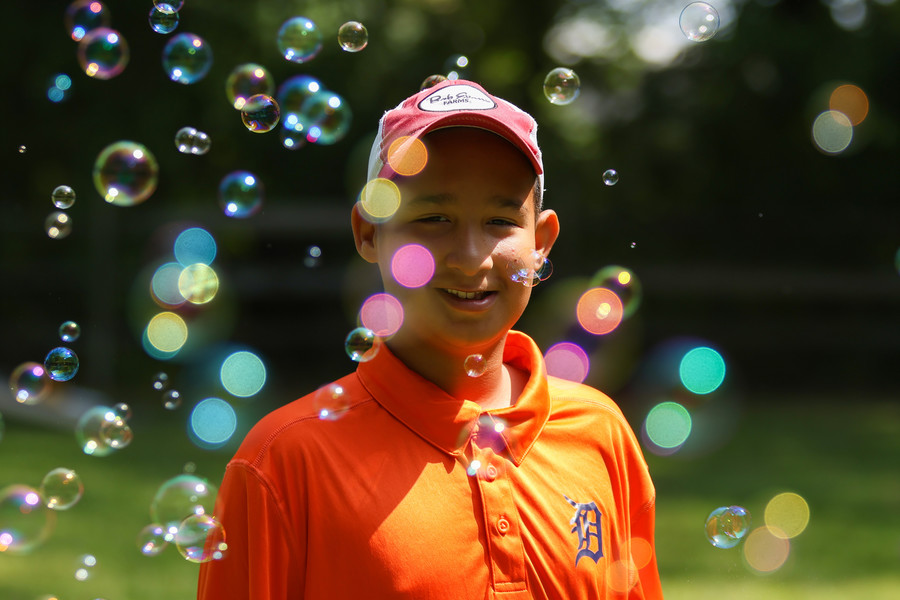 Portrait - 2nd place - Dwayne Collins, 11, smiles while surrounded by bubbles during Family fun day at The Ability Center in Sylvania.  (Jonathan Aguilar / The Blade)   (Jonathan Aguilar / The Blade)