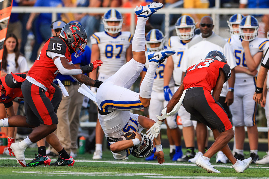 Sports - 1st place - Findlay’s Ryan Montgomery gets flipped into the air by Central’s Kevin Arnold causing him to leave the game at Central Catholic High School in Toledo. (Rebecca Benson / The Blade)   (Rebecca Benson / The Blade)