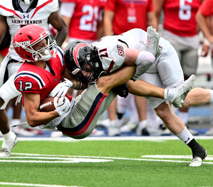 Sports Feature - HM - Dayton's Gavin Lochow gets tackled by St. Francis's Trey Mcleer after running for a first down. Dayton defeated St. Francis 18-10 at welcome stadium in Dayton, Ohio. (Erik Schelkun / Elsestar Images)   (Erik Schelkun / Elsestar Images)