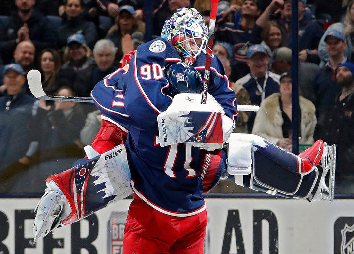 January - 2nd place sports feature - Columbus Blue Jackets goaltender Elvis Merzlikins (90) jumps into the arms of left wing Nick Foligno (71) after beating Carolina Hurricanes 3-2 in their NHL game at Nationwide Arena in Columbus. (Kyle Robertson/The Columbus Dispatch)