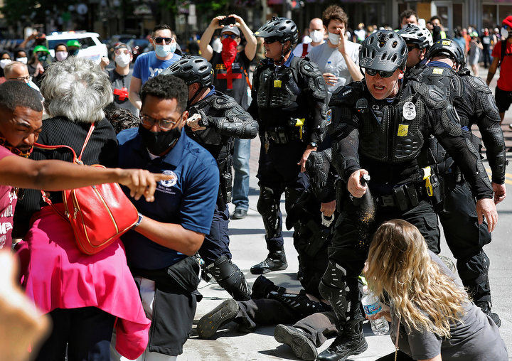 May - HM general news - Columbus City Council President Shannon Hardin, Congresswomen Joyce Beatty and Franklin County Commissioner Kevin Boyce  try to intervene as Columbus Police use pepper spraying on protesters during a protest on South High Street near the Ohio Statehouse  in Columbus. (Kyle Robertson / The Columbus Dispatch)