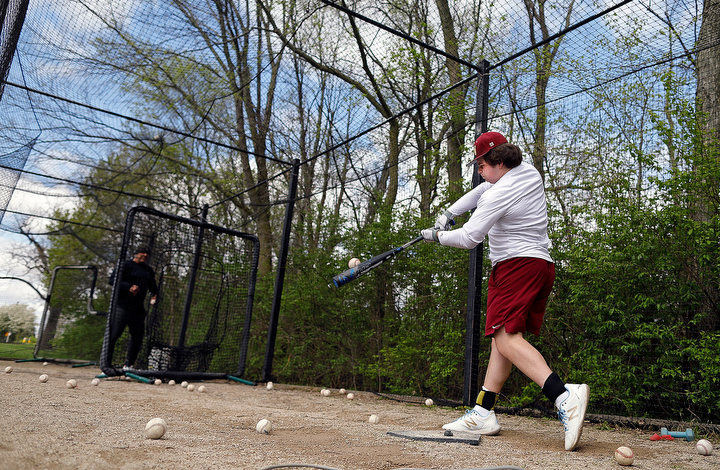 May - 1st place sports feature - Watterson High School sophomore baseball player Matthew Monesi (right) takes batting practice from his hitting coach Chris Carden at the batting cage at Darree Fields in Dublin.  Monesi is getting ready for summer baseball at end of the month after his high school season got canceled because of the pandemic.   (Kyle Robertson / The Columbus Dispatch)