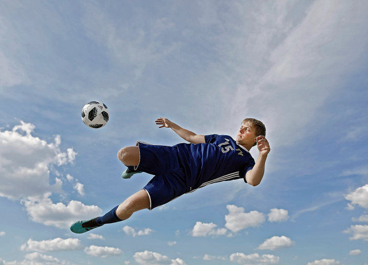 July - 1st place portrait - Parker Hamilton of Teays Valley High School is one of the winners in the 2020 Dispatch Scholar-Athlete program.  Parker kicks a soccer ball at Teays Valley High School in Ashville..  (Kyle Robertson / The Columbus Dispatch)