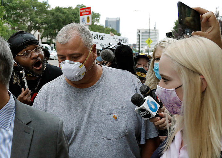 July - 2nd place spot news - Ohio House Speaker Larry Householder walks out of U.S. District Court as community protesters yell at him after charges that he participated in a racketeering conspiracy in Columbus. Householder and four colleagues were arrested by federal officials today as part of a bribery investigation involving the state’s $1 billion nuclear plant bailout and Householder’s maneuverings to secure support to lead the legislative chamber.  (Kyle Robertson / The Columbus Dispatch)